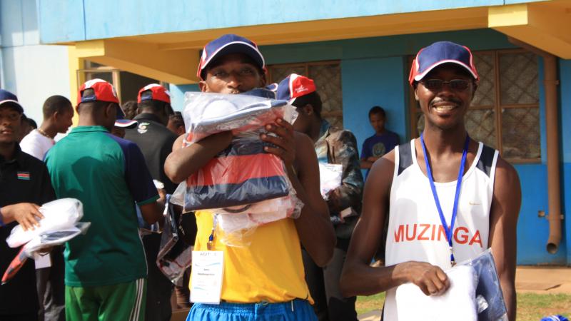 Athletes were delighted to receive equipment donated by Atos athletes holding packs from Atos
