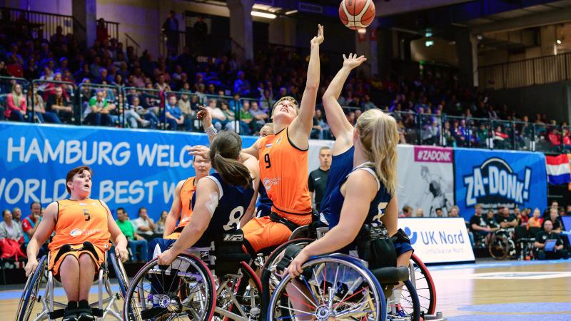 Netherlands Great Britain - Hamburg 2018 female wheelchair basketball players from Netherlands and Great Britain reaching up for the ball