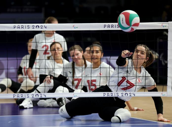 A female player spikes a ball during a warm up